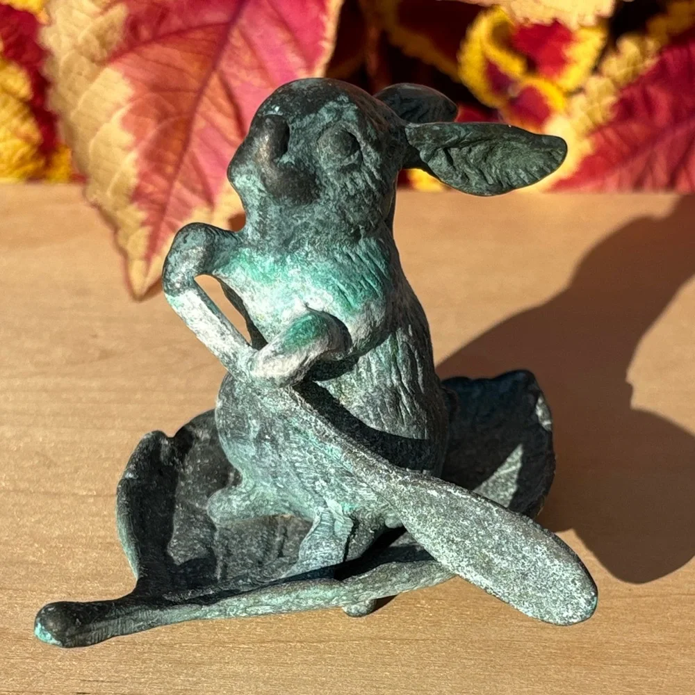 Vintage Bronze Rabbit Paddling A Leaf Boat